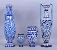 A GROUP OF FOUR 19TH CENTURY INDIAN MULTAN GLAZED POTTERY VASES, each decorated with floral panels