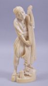 A JAPANESE MEIJI PERIOD ONE PIECE CARVED IVORY OKIMONO - FISHERMAN, the fisherman stood on a rocky