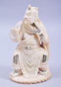 A CHINESE CARVED IVORY FIGURE OF A SEATED EMPEROR, carved and stained in a seated position holding