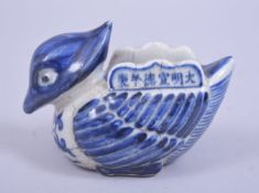 A CHINESE BLUE AND WHITE PORCELAIN WATER DROPPER in the form of a bird, with six character mark to