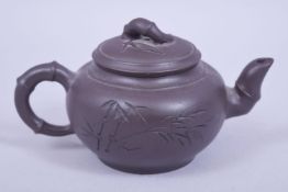 A CHINESE YIXING CLAY TEAPOT AND COVER of bamboo form, mark to base and underside of lid, 14cm spout