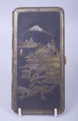 A JAPANESE DAMASCENED MIXED METAL CIGARETTE CASE, with a panel depicting buildings with mount fuji