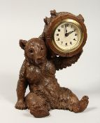 A GOOD VICTORIAN CARVED BLACK FOREST BEAR CLOCK. 7ins high.