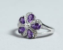 A SILVER, AMETHYST AND DIAMOND CLUSTER RING
