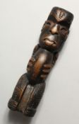 A SMALL CARVED WOOD TRIBAL FIGURE, possibly Maori. 7ins high.