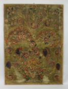 AN UNUSUAL WOOLWORK TAPESTRY PICTURE, portraying a vase of flowers and floral sprays, stretched