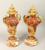 A SUPERB PAIR OF LOUIS XVITH RED MARBLE AND ORMOLU, TWO HANDLED URNS on an octagonal marble base.