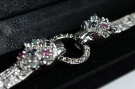 A SILVER RUBY EMERALD, SAPPHIRE PANTHER BRACELET.