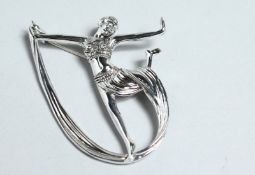 A SILVER ART DECO DANCER BROOCH.