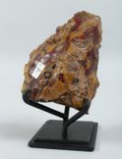 A YELLOW AND RED SPECIMEN on a stand. 5ins x 3ins