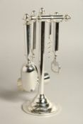 A SILVER PLATED FOUR PIECE BAR TOOLS SET on a stand.