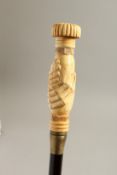 A BONE HANDLE WALKING STICK, CLASPED HANDS. 36ins long.