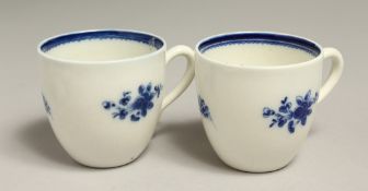 AN 18TH CENTURY CAUGHLEY PAIR OF COFFEE CUPS of uncommon shape with kick handle terminus painted