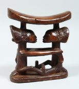 A TRIBAL CARVED WOOD PILLOW/ HEAD REST. 6.5ins high.