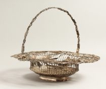 A GEORGE III SILVER WIRE WORK BASKET, oval with fruiting vines an wheat ears with pierced handles.