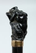 A VICTORIAN WALKING CANE with mermaid handle.
