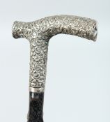 A VICTORIAN WALKING STICK with ornate silver handle. London 1899 36ins long