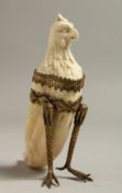 AN UNUSUAL EUROPEAN IVORY TOOTH CARVING with the head of an eagle with gilt mounted legs. 4.75ins