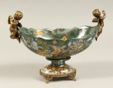 A FRENCH PORCELAIN AND ORMOLU TWO HANDLED OVAL PEDESTAL BOWL. 11ins diameter.