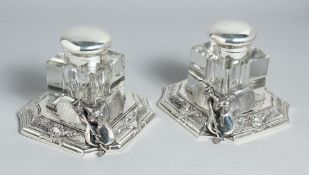 A PAIR OF HUNTING INKSTONES with foxes mask, whip etc.