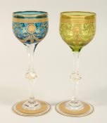 A PAIR OF GILT DECORATED WINE GLASSES. 7.75ins high.