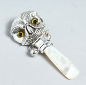 A SILVER AND MOTHER OF PEARL BABY'S RATTLE
