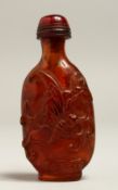 A CARVED AMBER SNUFF BOTTLE
