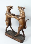 A GOOD 19TH CENTURY BLACK FOREST TWO HOUNDS STICK STAND, two dogs on a rustic base. 27ins high.
