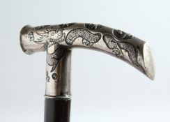 A JAPANESE SILVER-HANDLED WALKING STICK with Chinese design carved rosewood shaft. 35ins long