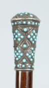 A VICTORIAN WALKING CANE with silver and turquoise handle. 36ins long.