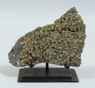 A PYRITE SPECIMEN on a stand.