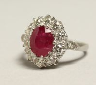 A VERY GOOD 18CT WHITE GOLD RUBY AND DIAMOND CLUSTER RING