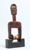 A CARVED WOOD TRIBAL PULLEY 9.5ins