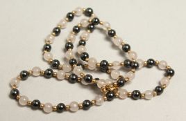 A MOTHER OF PEARL AND GOLD NECKLACE.