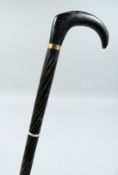 A VICTORIAN EBONY WALKING STICK 37ins long.