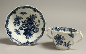 AN 18TH CENTURY WORCESTER GOOD CHOCOLATE OR CAUDLE , TWO HANDLED CUP AND SAUCER, printed with