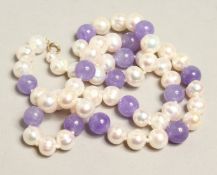 A 14CT GOLD AND LAVENDER STONE NECKLACE.