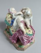 A GOOD 18TH CENTURY MEISSEN PORCELAIN GROUP a baby on a bed playing with a dog. Cross swords mark in
