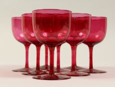A SET OF EIGHT CRANBERRY WINE GOBLETS. 4.5ins high.