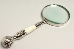 A MAGNIFYING GLASS WITH CHROME AND MOTHER OF PEARL HANDLE.