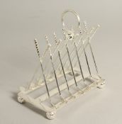 A SILVER PLATE GOLFING SIX DIVISION TOAST RACK with cross clubs and ball.