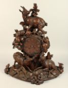 A VERY GOOD 19TH CENTURY BLACK FOREST CARVED WOOD MANTLE CLOCK, with eight day movements, striking