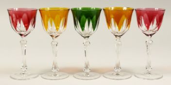 A SET OF FIVE CUT GLASS WINE GLASSES, comprising: a pair of amber tinted, a pair of ruby tinted, a