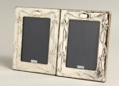 A PAIR OF SILVER PHOTOGRAPH FRAMES in the art nouveau style 7.5s x 6.5ins.
