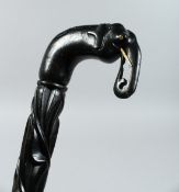 A CEYLONESE EBONY WALKING STICK with elephant handle. 33ins long.