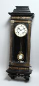 A LATE VICTORIAN EBONISED VIENNA WALL CLOCK, with eight day movement striking on a gong, white