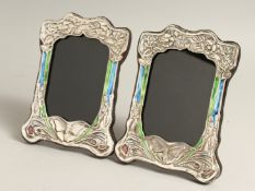 A PAIR OF SILVER AND ENAMEL BUTTERFLY PHOTOGRAPH FRAMES 8ins x 6ins.