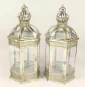 A PAIR OF METAL AND GLASS HEXAGONAL LANTERNS.