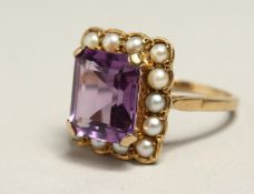 AN AMETHYST AND PEARL RING