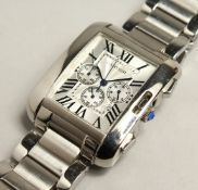 A CARTIER CHROME TANK WATCH AND BRACELET. Boxed.